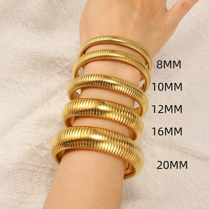 Close-up of gold titanium steel snake bracelets in 8mm to 20mm widths on a model wrist
