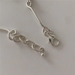 Macro shot of S925 sterling silver bracelet showing lobster clasp and extender chain