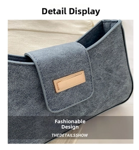 Detail shot of the golden metal buckle and denim texture on the stylish shoulder bag