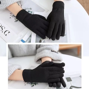 Close-up of black knitted thermal gloves with a soft brushed texture for winter warmth