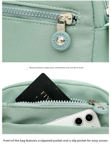Detail of green Oxford fabric crossbody bag showing front zipper pocket and phone storage