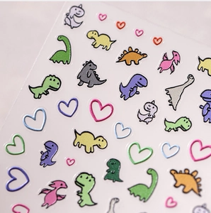 Macro detail of 3D cartoon dinosaur nail stickers with colorful glitter texture