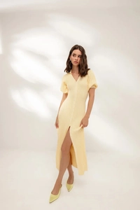 Detail of V-neckline and button-down front on a yellow puff sleeve knit dress