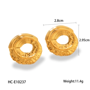 Detail showing 18k gold plated hammered texture and wavy pattern on hollow hoop earrings