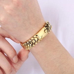 Close-up of gold polished stainless steel dragon scale bracelet on a wrist