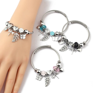 Detail view of steel wire charm bracelet with butterfly, leaf and heart pendants
