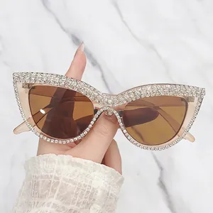 Cat eye oversized sunglasses with champagne frames and crystal rhinestone accents