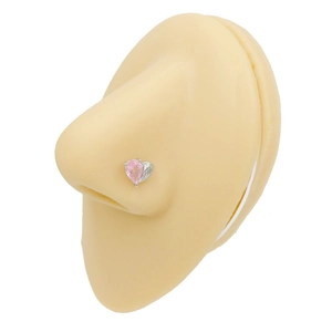 Pink heart-shaped zircon nose stud shown on a silicone model for piercing details