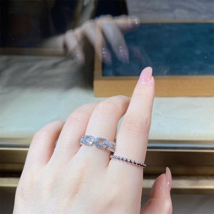 Macro shot of silver S925 stacking rings with hollow chain design and zircon inlays