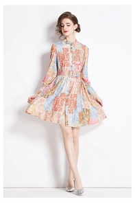 Detail of bohemian floral print dress featuring paisley patterns and an adjustable waist belt