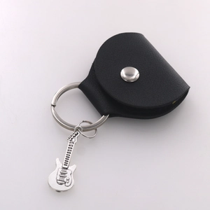 Detail of black leather guitar pick pouch with an electric guitar keychain pendant