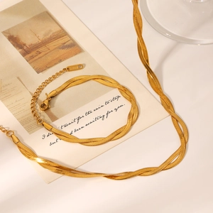 Close-up of 18K gold-plated double-layer snake chain necklace and S.STEEL stamp bracelet