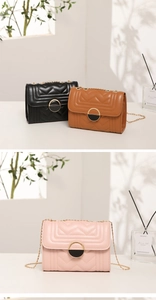 Detailed view of quilted leather handbags in black, brown, and pink with gold chain straps