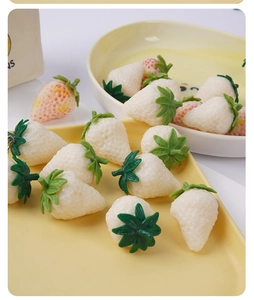 Macro detail of realistic white strawberry resin charms for DIY jewelry and keychains