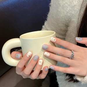 Handmade press-on nails featuring blue-white bohemian moon and star golden charms