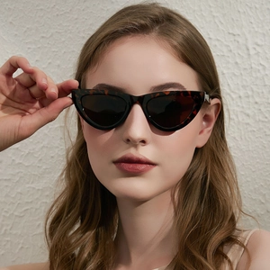 Stylish cat-eye tortoiseshell sunglasses with dark lenses on female model