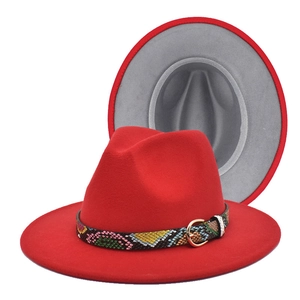 Detail of red fedora hat with snakeskin leather band and contrast grey interior lining