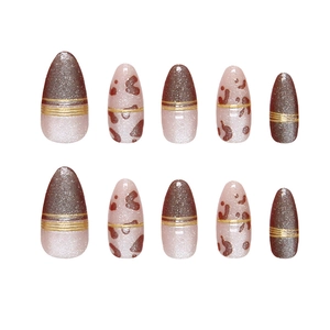 Handmade almond press-on nails with red-brown cat eye finish and gold line accents