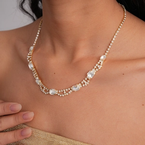 Macro detail of luxury double-layered gold necklace with square and round rhinestones