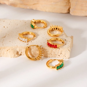 Macro shot of gold hoop earrings with multi-colored rectangular cubic zirconia insets