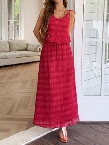Detail of red pleated two-piece set featuring camisole top and long skirt with drawstrings