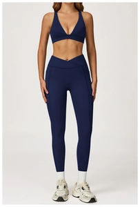 Detail of navy yoga set featuring V-shaped cross waistband and functional side pockets