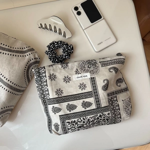 Detail of simple wish cotton linen makeup bag with vintage black paisley print texture
