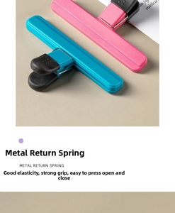 Macro detail of T-shaped food sealer clips with metal springs in pink and blue colors