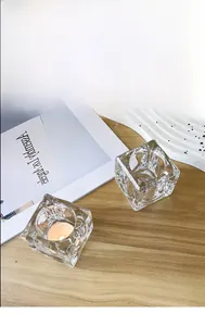 Detailed view of luxury ice-textured crystal glass tea light holders on a table
