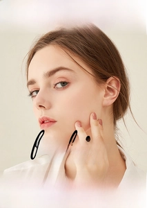 Detail view of moissanite hoop earrings featuring a stylish multi-loop silver design