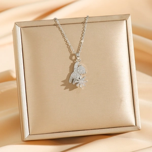 Mechanical bear pendant necklace with sparkling cubic zirconia on a luxury jewelry box