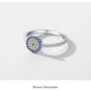 Macro shot of silver ring featuring evil eye motif with blue and white zircons