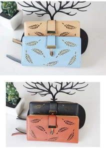 Detail of laser-cut leaf pattern on women's long wallets with elegant metal charms