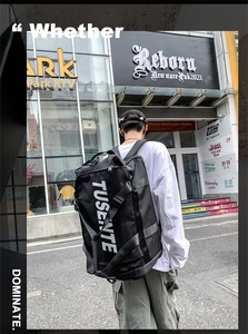 Black Oxford cloth travel backpack showing durable side handles and TUSENTE lettering