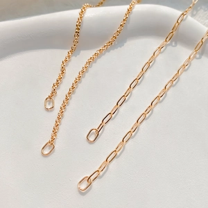 Detail of 18K gold plated Rolo and Paperclip chains showcasing fine metalwork craftsmanship