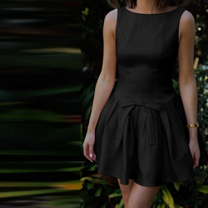 Elegant black sleeveless mini dress with waist bow and pleated hem for autumn 2024