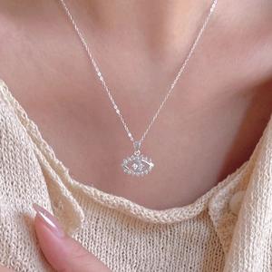 Detailed view of S925 silver devil eye necklace with zircons worn by a model