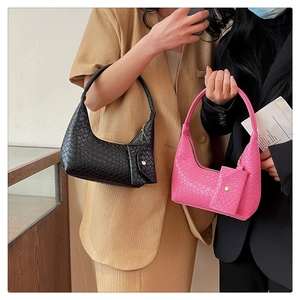 Detail of woven texture hobo bags in black and pink with matching coin purse charms