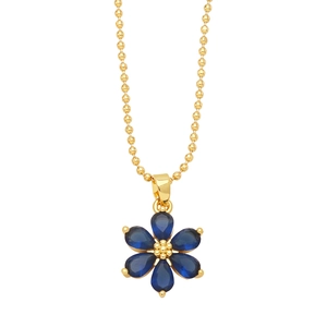 Detailed macro of gold beaded chain and flower pendant with six blue pear-shaped petals