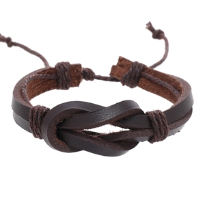 Detail of a brown woven leather bracelet featuring a central knot and adjustable cord closure