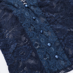 Detail view of navy blue lace fabric texture with five matching round decorative buttons