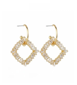 Detail shot of geometric square gold earrings with channel-set baguette cubic zirconia stones