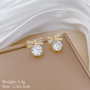 Macro detail of gold butterfly crystal studs with weight and size specifications