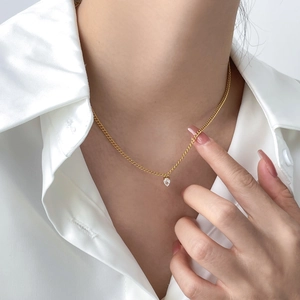 Double-layer gold snake chain necklace with water drop zircon pendant on model