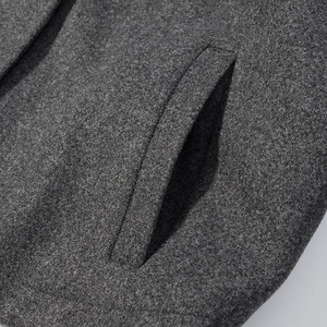 Detail shot of high-quality dark grey wool fabric and neatly stitched side pocket