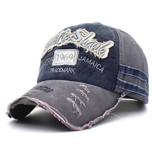 Close-up of vintage washed cotton baseball cap with 1969 embroidery and distressed edges