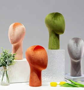 Velvet mannequin heads in pink, orange, green and grey colors for hat and wig display