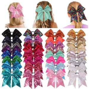 Detail of colorful sequined oversized bow hair ties for girls in various vibrant gradient shades