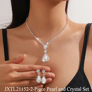 Close-up of pearl and rhinestone teardrop necklace set worn on a female model