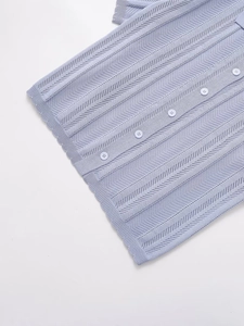 Detail of light purple knit short sleeve top with hollow-out patterns and white buttons